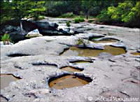 Time and water beautifully sculpted this rock shelf just above the falls -- click to see larger size